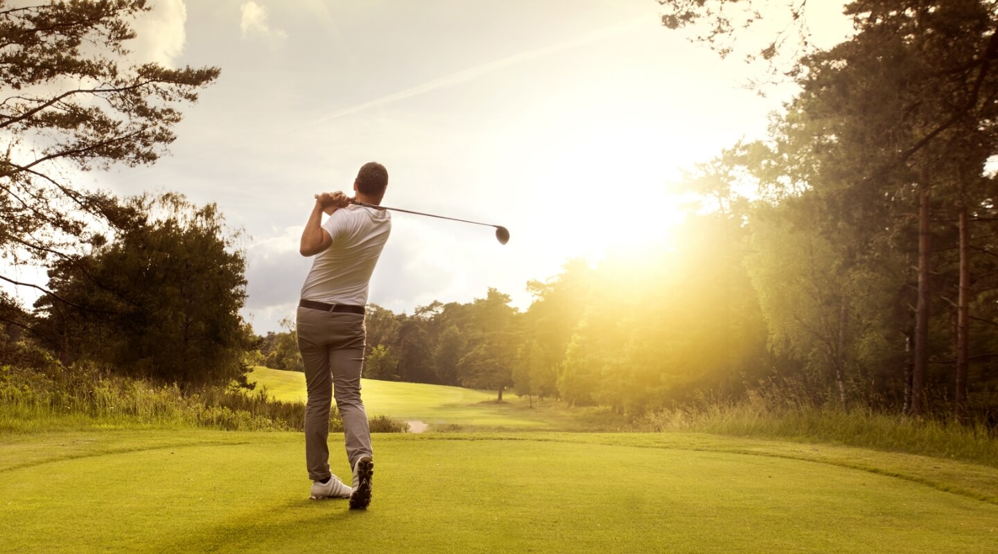 a man's follow through on a golf drive